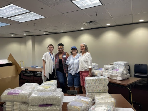 Success By 6 Shared Services Resources and Support Coordinator Tori Carter, United Way volunteers Summer McAfee and Melanie Ross, and United Way volunteer and donor Diane Ireson organize diapers for distribution to local child care centers.